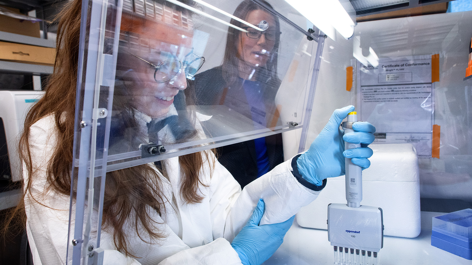 a student and a researcher in a lab