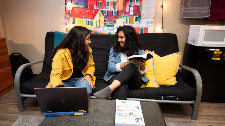 Two students study together in Daum Residence Hall room.