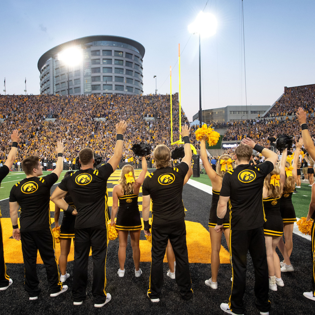 Iowa cheerleaders waving to UI Stead Family Children's Hospital