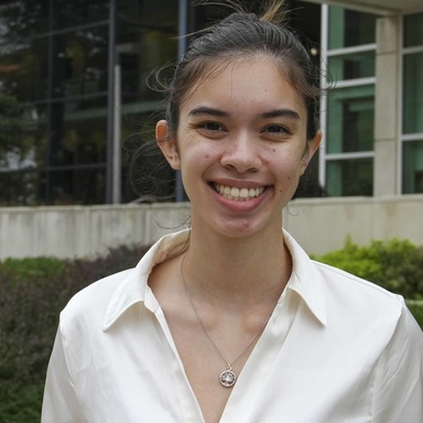 Elana walters smiling in front of a university building.