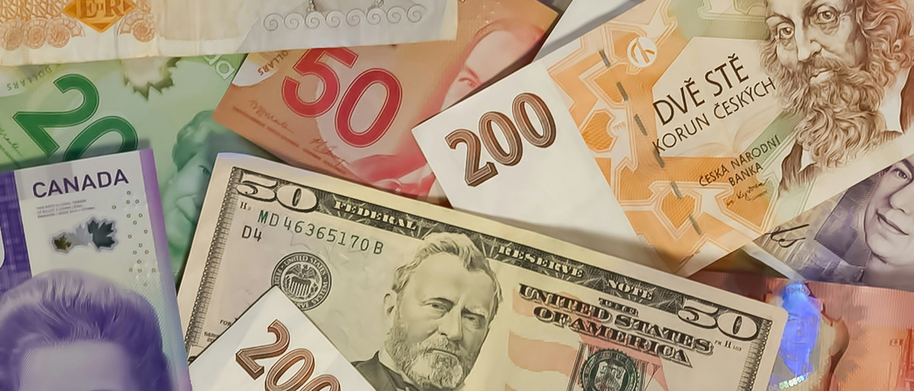 various world currencies, including a U.S. fifty dollar bill