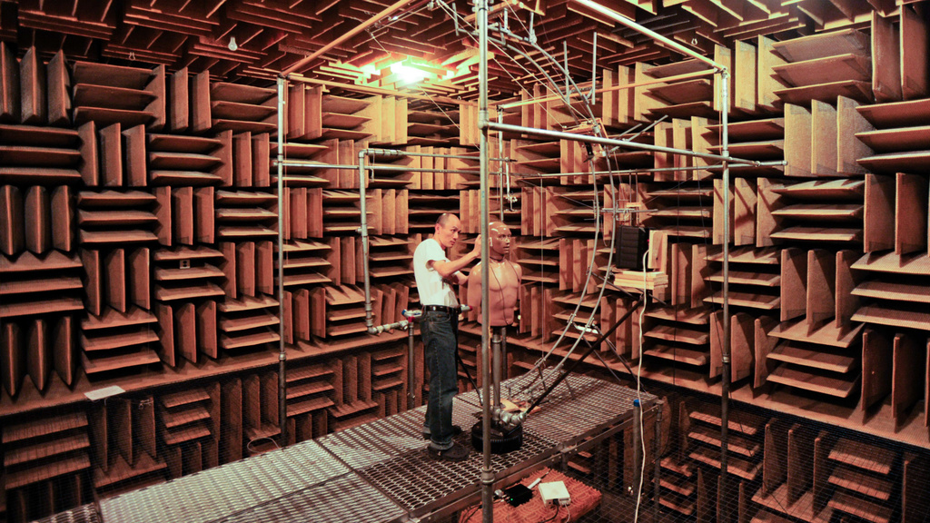 Man performing maintenance in a sound-proof room.