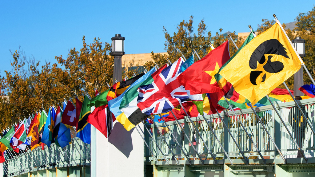 Internation flags line the pedestrian bridge along the Iowa River.