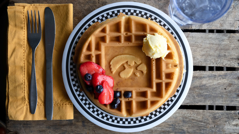 Detail of plate with waffle on it with a Tigerhawk logo in the waffle.