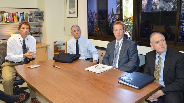 Iowa grad Timothy Holtz seated with Dr. Anthony Fauci