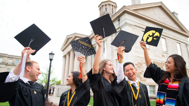 Iowa graduates celebrating near the Old Capitol