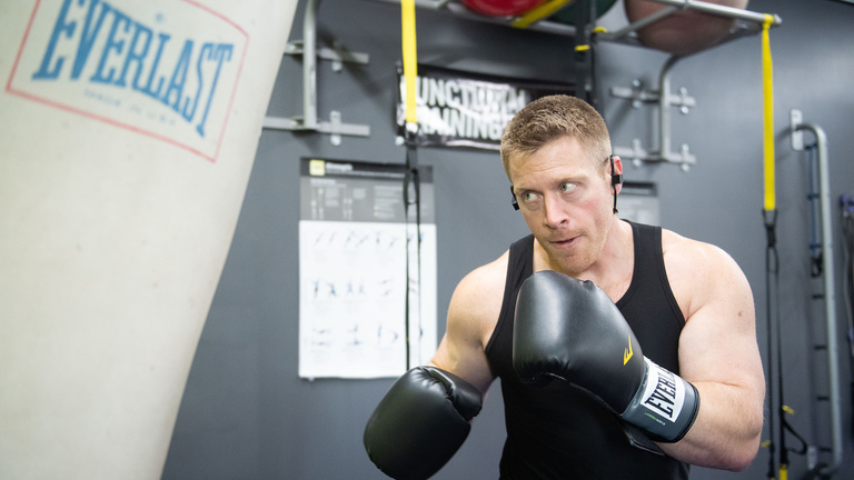 UIHC cancer clinical trials patient and Crown Cover founder Jordan Hauck working out in boxing gym
